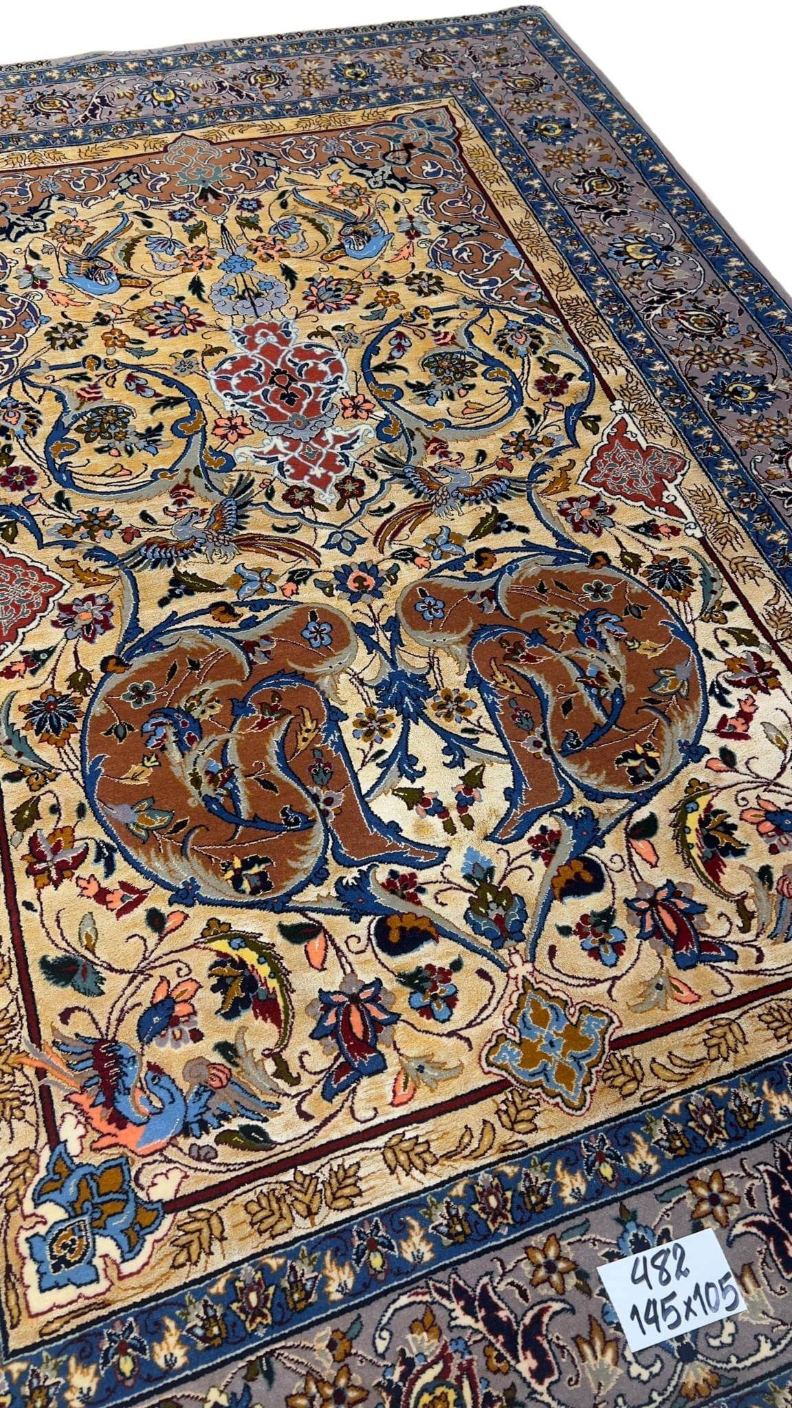 Hand-knotted Persian Isfahan rug with bird and floral motifs.
